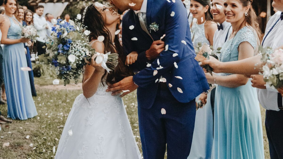 Bride and father stepping out of a Rolls-Royce at a wedding venue