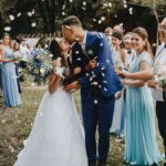 Bride and father stepping out of a Rolls-Royce at a wedding venue